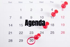 a calendar with red push buttons pinned to it